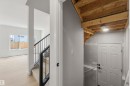 Interior staircase with black metal railings and carpeted treads - 5872 Raven Crescent Nw, Edmonton, AB  - Indoor Photo Showing Other Room 