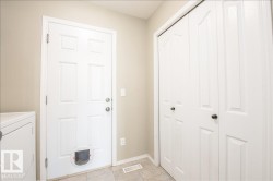 Mudroom entry with a paneled door, built-in pet door, and bifold closet doors - 