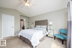 Carpeted room featuring vaulted ceilings and a ceiling fan with integrated lighting - 