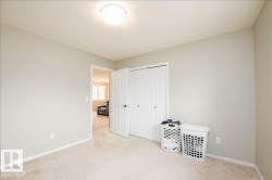 Carpeted room featuring light gray painted walls and white baseboards - 