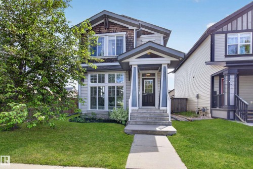 Two-story residence featuring light-toned siding and dark trim accents - 9847 220 Street Nw, Edmonton, AB - Outdoor With Facade