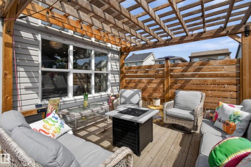 Spacious wood-finish deck featuring a slatted wood pergola and privacy fence - 9847 220 Street Nw, Edmonton, AB - Outdoor With Deck Patio Veranda