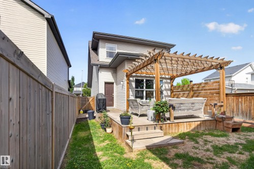 Expansive rear deck featuring a wooden pergola, privacy screen, and direct home access - 9847 220 Street Nw, Edmonton, AB - Outdoor With Deck Patio Veranda