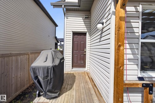 Exterior siding with a wood-finish deck and privacy fence - 9847 220 Street Nw, Edmonton, AB - Outdoor With Deck Patio Veranda With Exterior