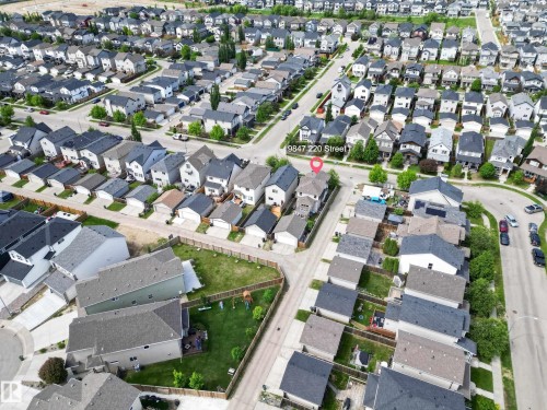 Aerial perspective of a developed residential area featuring numerous single-family homes with varied rooflines and exterior finishes - 9847 220 Street Nw, Edmonton, AB - Outdoor With View