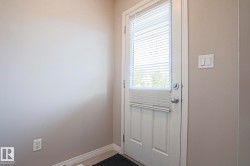 White paneled door with integrated blinds and brushed nickel hardware - 