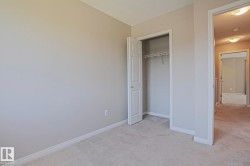 Neutral-toned walls complement plush carpeting throughout this space - 