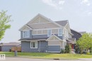 Multi-level residence featuring a blue and tan siding exterior with white trim - 489 Orchards Boulevard Sw, Edmonton, AB  - Outdoor With Facade 