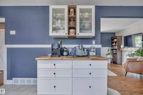 Custom built-in cabinetry with a wood-finish countertop and white shaker-style drawers - 5302 52 Ave, Wetaskiwin, AB - Indoor