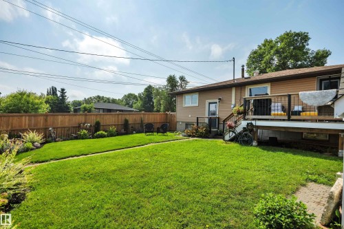 Expansive rear yard featuring a large lawn area and a wood privacy fence - 5302 52 Ave, Wetaskiwin, AB - Outdoor With Deck Patio Veranda