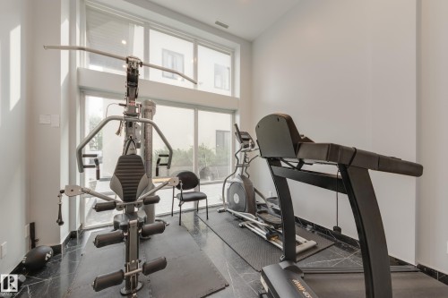Workout area featuring a high ceiling and baseboards - #403 1350 Windermere Wy Sw, Edmonton, AB - Indoor Photo Showing Gym Room