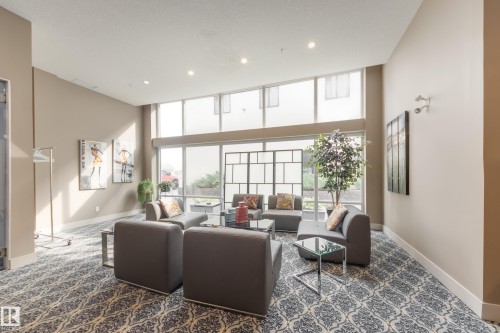 Lobby featuring floor to ceiling windows, recessed lighting, and a towering ceiling - #403 1350 Windermere Wy Sw, Edmonton, AB - Indoor