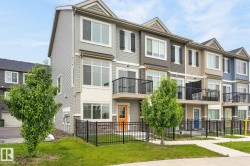 Contemporary townhome exterior featuring multi-pane windows and a private balcony - 