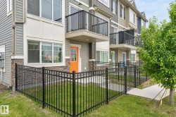 Contemporary townhouse exterior featuring horizontal siding and stone veneer accents - 