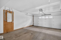 Integrated garage featuring a segmented overhead door with clear window panels and an automatic opener - 