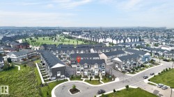 Aerial overview showcasing a residential development with townhomes and detached properties - 