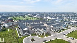 Expansive aerial perspective showcasing a residential development featuring multiple townhome blocks and single-family residences - 