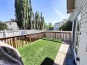 Outdoor deck with wood railings, synthetic grass area, and white privacy fencing - 215 Peter Close, Edmonton, AB  - Outdoor With Deck Patio Veranda With Exterior 