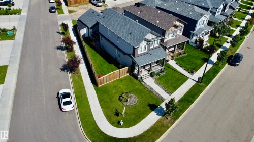 Two-story residence featuring a covered front porch, an attached garage, and a fenced backyard - 17359 49 Street Nw, Edmonton, AB - Outdoor With View