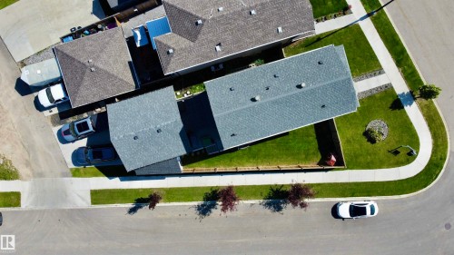 Aerial perspective showcasing a corner lot with a residential property featuring a gray shingled roof and a manicured lawn - 17359 49 Street Nw, Edmonton, AB - Outdoor