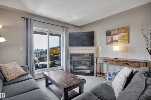 #411 4415 48 St, Leduc, AB - Indoor Photo Showing Living Room With Fireplace