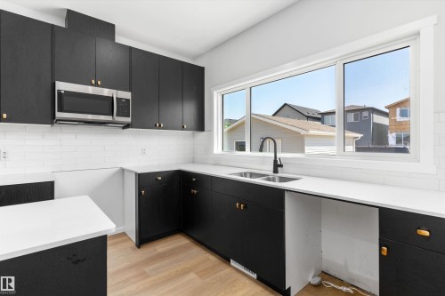 2463 Alces Link Sw, Edmonton, AB - Indoor Photo Showing Kitchen With Double Sink