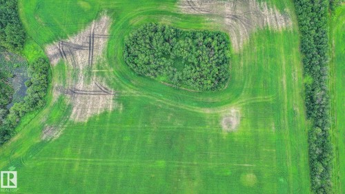 Expansive green acreage featuring a central wooded area, a wooded perimeter, and a distinct agricultural pattern - Sw-28-56-10 -W4, Rural St. Paul County, AB 