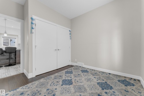 Room featuring light gray painted walls and dark wood-finish flooring - 4506 49 Avenue, Beaumont, AB - Indoor Photo Showing Other Room
