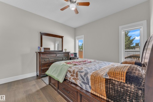 Bedroom featuring wood-finish flooring, light grey painted walls, and a ceiling fan with integrated lighting - 4506 49 Avenue, Beaumont, AB - Indoor Photo Showing Bedroom