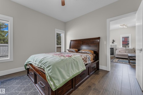 Spacious room featuring wood-finish flooring, light grey walls, and white trim - 4506 49 Avenue, Beaumont, AB - Indoor Photo Showing Bedroom