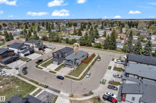 Contemporary residential property featuring a gray exterior, dark shingle roofing, and an attached garage - 4506 49 Avenue, Beaumont, AB - Outdoor With View
