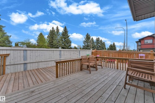 Expansive outdoor deck featuring wood plank flooring and robust wood railings - 4506 49 Avenue, Beaumont, AB - Outdoor With Deck Patio Veranda With Exterior