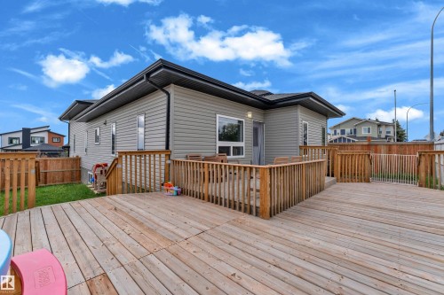 Expansive wooden deck with natural wood railing, offering multiple levels and direct access to the home - 4506 49 Avenue, Beaumont, AB - Outdoor With Deck Patio Veranda With Exterior