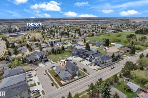 Aerial view of a residential property with a light-colored exterior and fenced yard, situated in a neighborhood with varying architectural styles - 4506 49 Avenue, Beaumont, AB - Outdoor With View