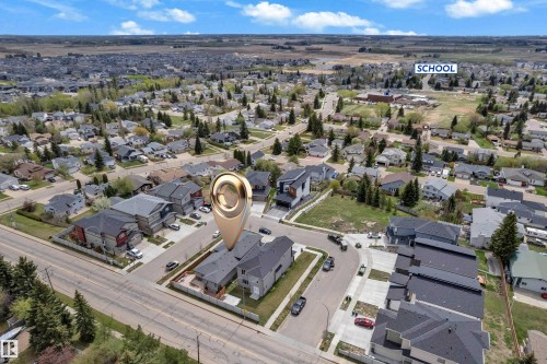 Aerial overview featuring a residential neighborhood with established trees and street infrastructure - 4506 49 Avenue, Beaumont, AB - Outdoor With View