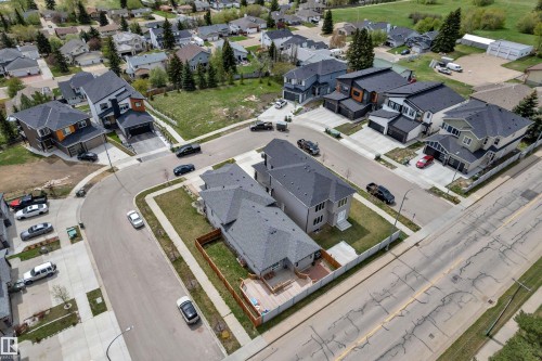 Aerial perspective showcasing a residential neighborhood with diverse architectural styles, featuring new construction homes - 4506 49 Avenue, Beaumont, AB - 