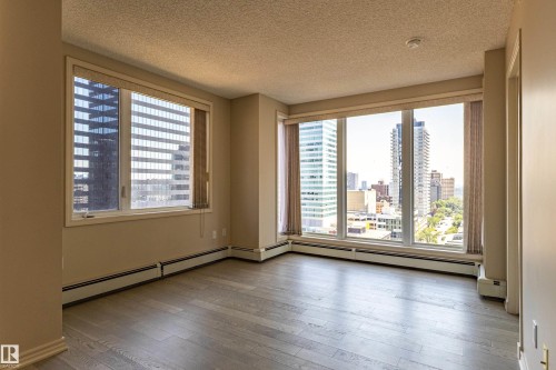 Expansive window wall with cityscape scenery - #1501 10180 104 St Nw, Edmonton, AB - Indoor Photo Showing Other Room