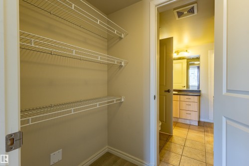 Closet with wire shelving and a neutral wall palette - #1501 10180 104 St Nw, Edmonton, AB - Indoor With Storage