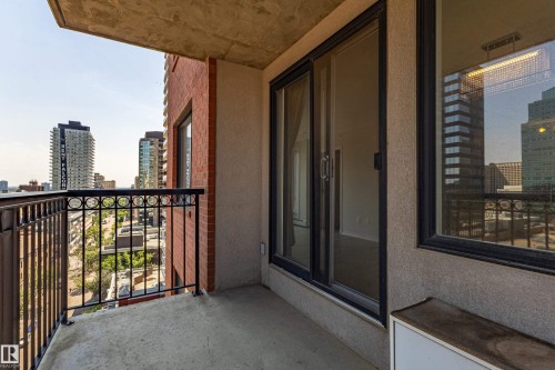 Private balcony with a concrete floor and a decorative metal railing - #1501 10180 104 St Nw, Edmonton, AB - Outdoor With Exterior