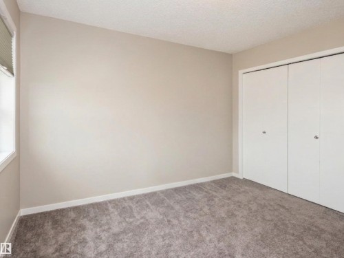Neutral-toned walls complement the gray carpeting - 17263 9 Avenue Sw, Edmonton, AB 