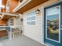 Private balcony featuring a textured concrete surface and glass panel railing - 17263 9 Avenue Sw, Edmonton, AB 