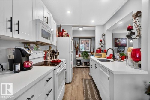 #406 5125 Riverbend Rd Nw, Edmonton, AB - Indoor Photo Showing Kitchen With Double Sink