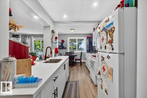 #406 5125 Riverbend Rd Nw, Edmonton, AB - Indoor Photo Showing Kitchen With Double Sink