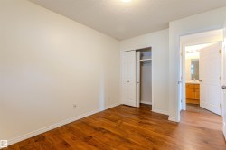 Room with wood-finish flooring, white walls, and white trim - 
