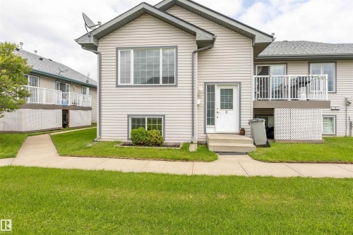 Light-toned siding exterior with a contrasting dark roofline - #D 10102 103 St, Morinville, AB - Outdoor With Balcony