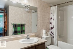 Bathroom vanity with an integrated sink, laminate countertop, and wood-finish cabinetry - 
