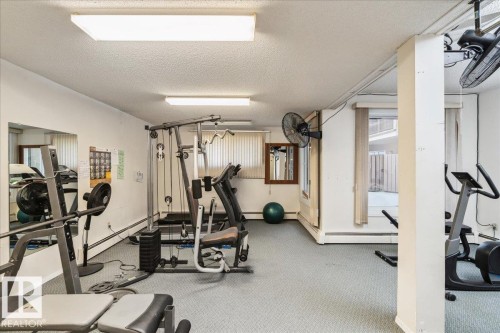 Dedicated fitness space with light grey carpet flooring and white painted walls - #112 2904 139 Av Nw, Edmonton, AB - Indoor Photo Showing Gym Room