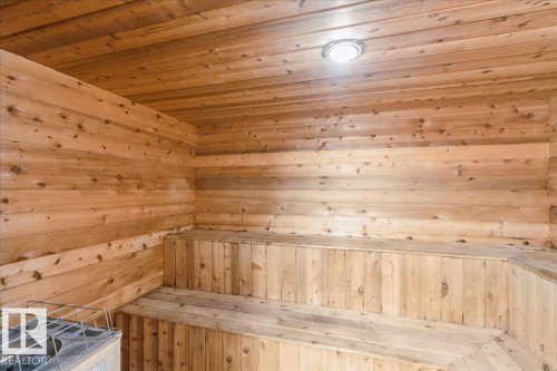 Cedar-lined sauna featuring multi-level wood benches, slat wall and ceiling construction, and a ceiling-mounted light fixture - #112 2904 139 Av Nw, Edmonton, AB - Indoor Photo Showing Other Room