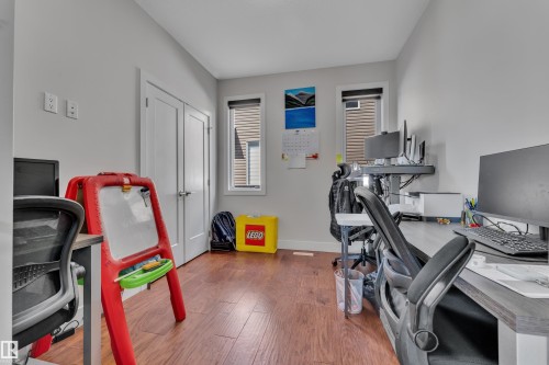 Hardwood-finish flooring complements the light-toned walls - 3001 55 Street, Beaumont, AB - Indoor