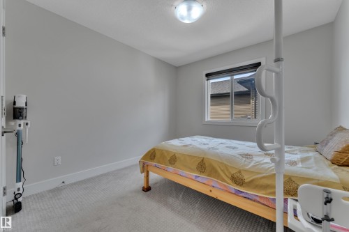 Neutral gray walls with white trim, carpeting, and a window with black blinds - 3001 55 Street, Beaumont, AB - Indoor Photo Showing Bedroom